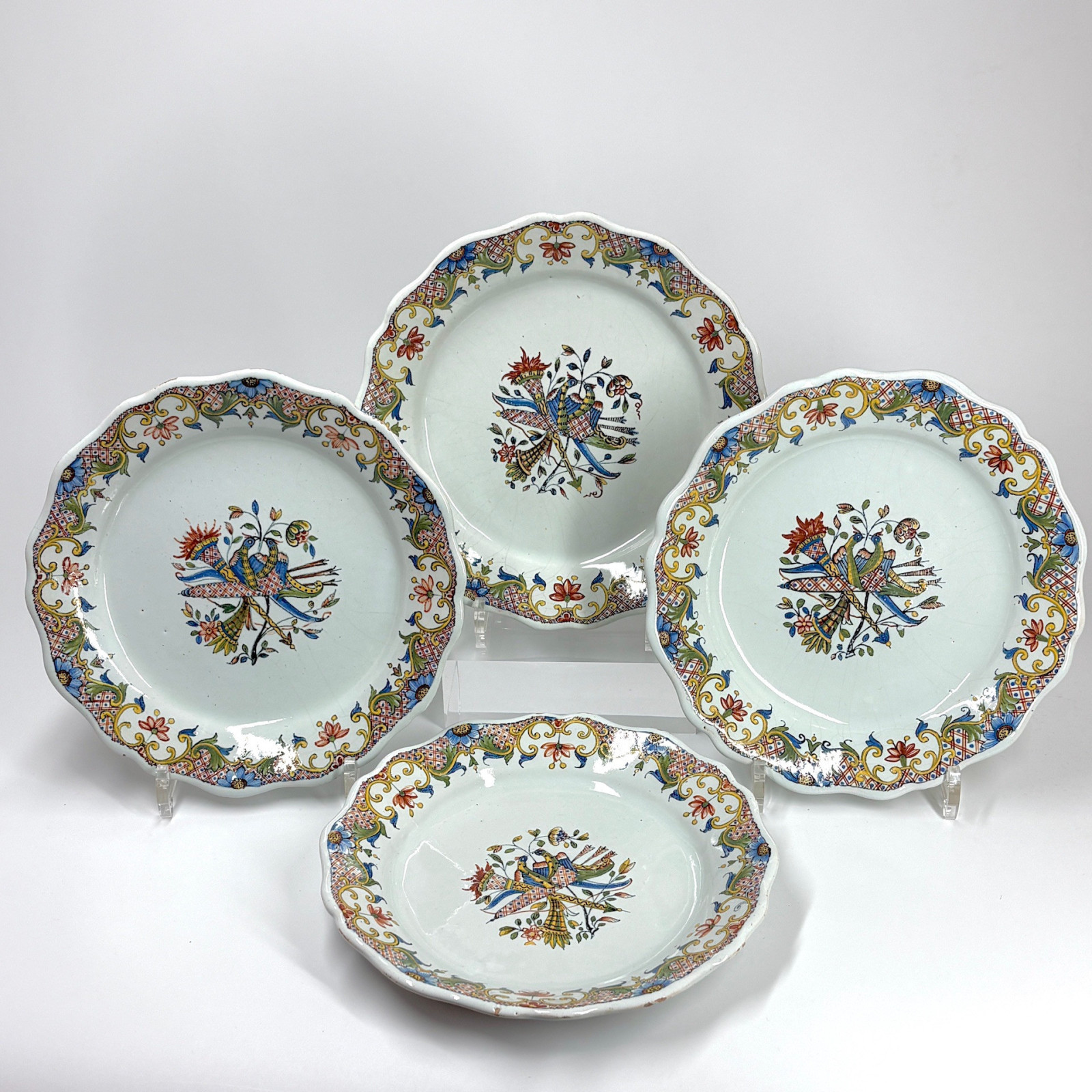 Four Rouen earthenware plates "with quiver" - Eighteenth century